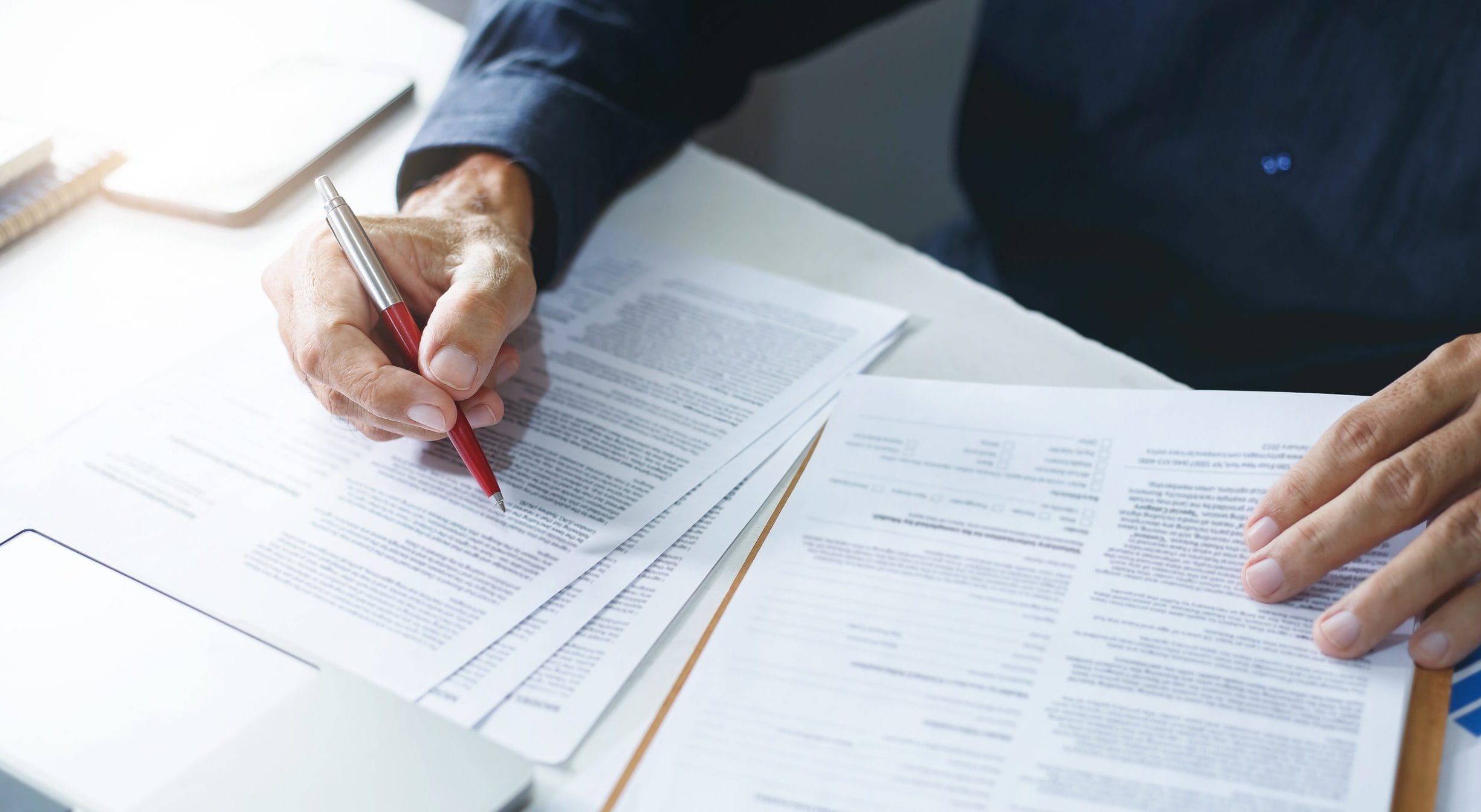 Legal documents being reviewed to determine divorce waiting periods by state.