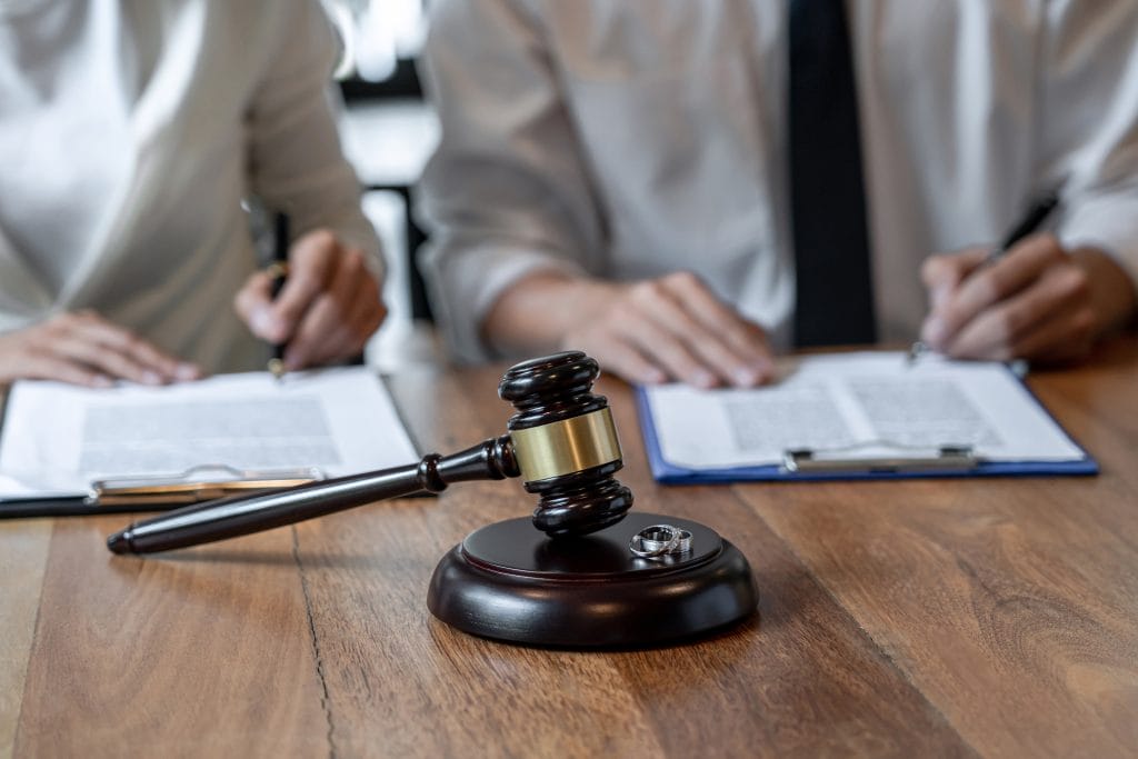What to Expect When Divorcing a Narcissist. Bloomington-Normal Divorce Attorneys Koth Gregory & Nieminski Law Firm. Clients meeting with lawyer to discuss divorce from narcassist, with rings off.