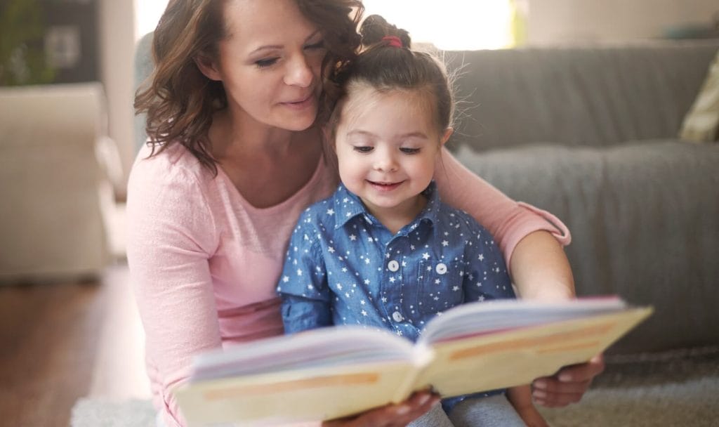 Same-sex parentage and child custody attorneys in Bloomington-Normal Illinois – mother and daughter reading a picture book together – Koth Gregory & Nieminski Law Firm