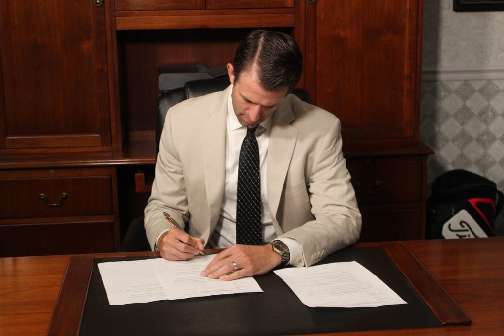 Bloomington-Normal Estate Planning Attorney Dustin Koth of Koth Gregory & Nieminski reviewing Special Needs Trust documents.