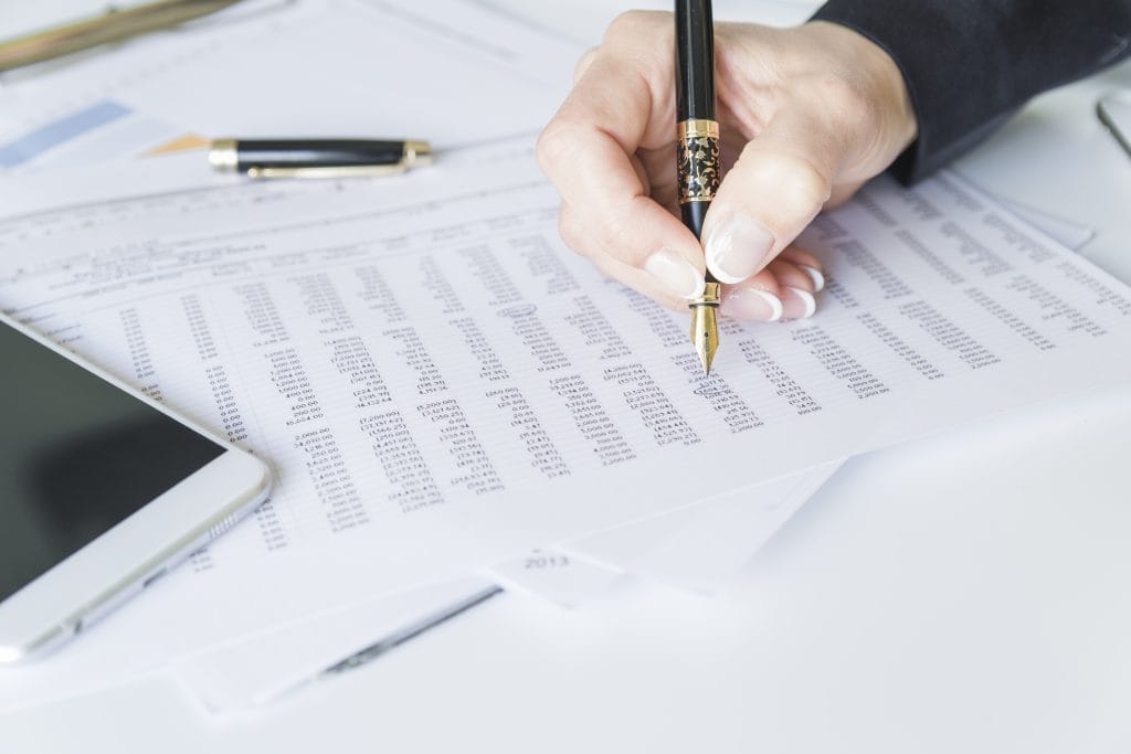 Bloomington-Normal expert family law atorneys from Koth Gregory & Nieminski Law firm working on financial documents for temporary maintence relief.