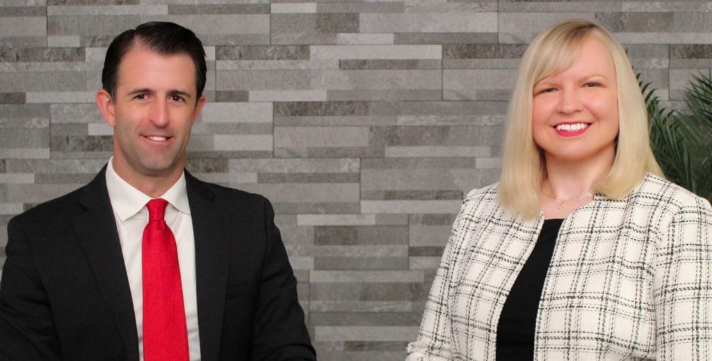 Bloomington-Normal Illinois Family Law Attorneys Dustin Koth and Kristin Nieminski discussing with a client about alimony during a meeting in the conference room at Koth Gregory & Nieminski Law Firm offices in Downtown Bloomington.