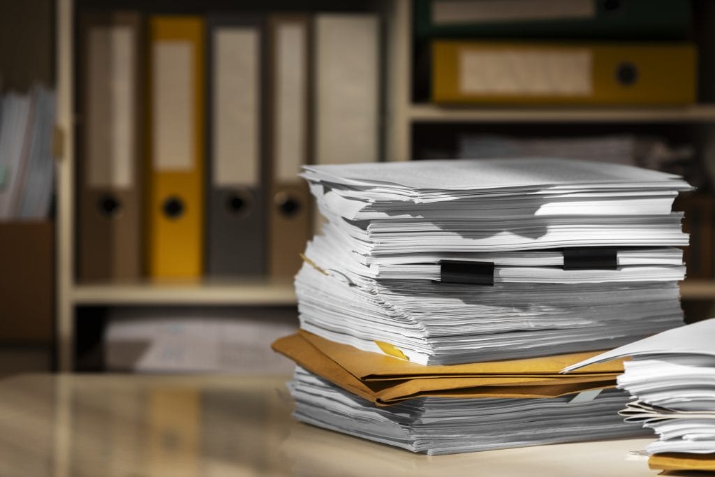 Organized document stack from car accident personal injury victim who has kept files of their injuries | personal injury attorneys koth gregory & nieminski bloomington-normal illinois 