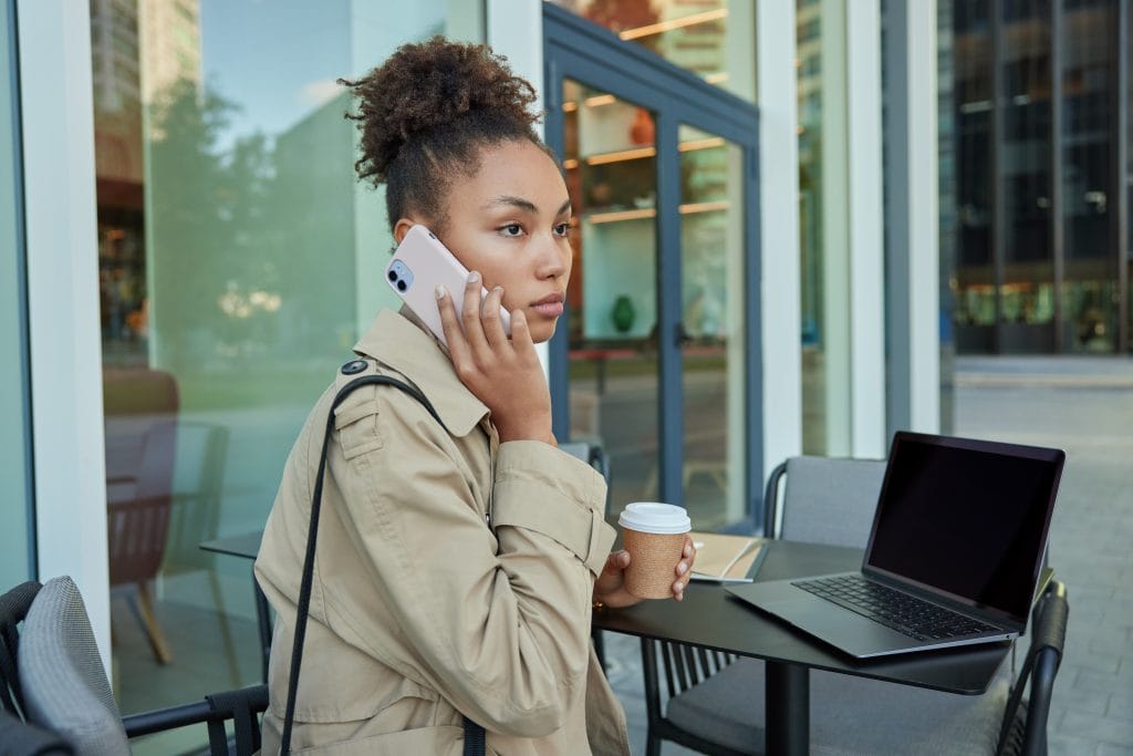 Car accident victim on the phone with insurance company in Bloomington Normal, Illinois after her car accident 